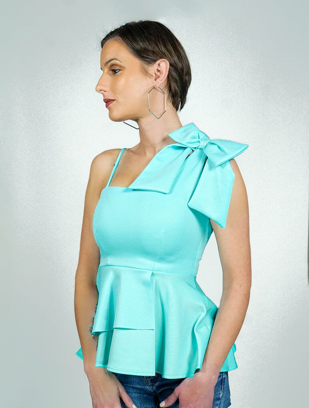 Model is wearing One Shoulder top with Accent Bow &amp; Ruffle bottom She&#39;s Elegant 